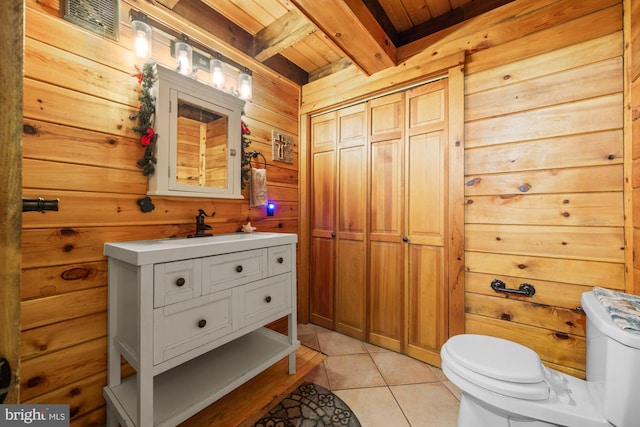 74 Madison Rd, Elmer, NJ 08318 - bathroom featuring wood ceiling with exposed beams, toilet, vanity, wood walls, and tile patterned flooring