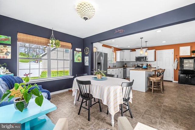 dining area with recessed lighting and baseboards