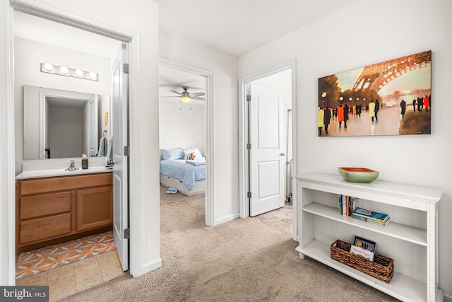 corridor with light carpet and baseboards