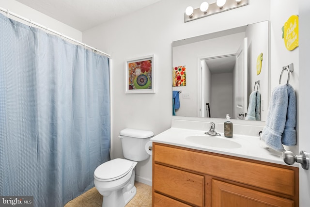 bathroom with vanity, toilet, and tile patterned flooring