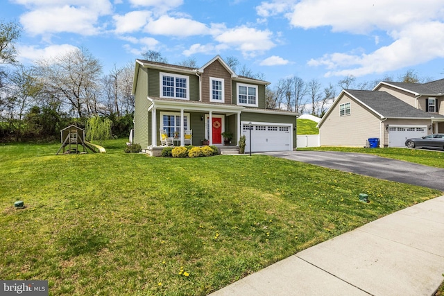 traditional home featuring aphalt driveway, a playground, covered porch, a front yard, and a garage