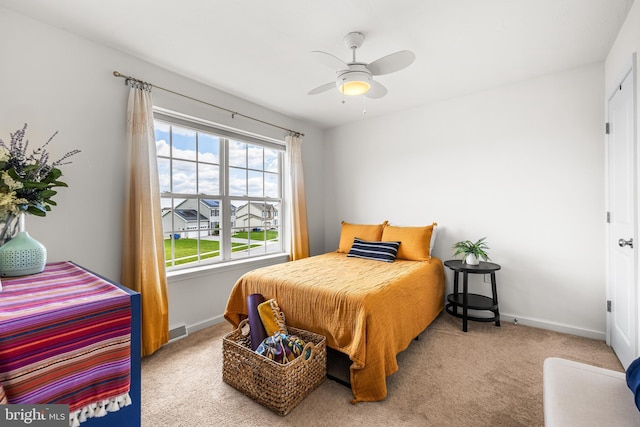 carpeted bedroom featuring visible vents, baseboards, and ceiling fan