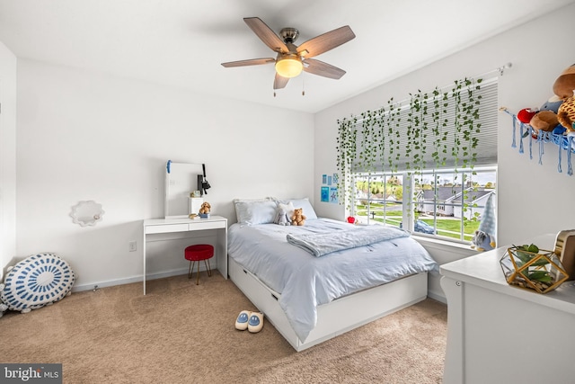 bedroom with light carpet, a ceiling fan, and baseboards