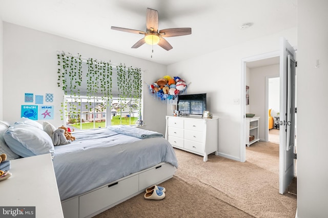 bedroom with a ceiling fan and light colored carpet
