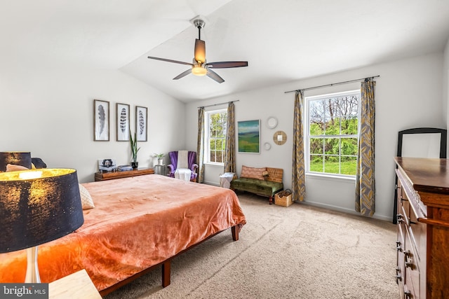 bedroom with carpet, lofted ceiling, baseboards, and a ceiling fan