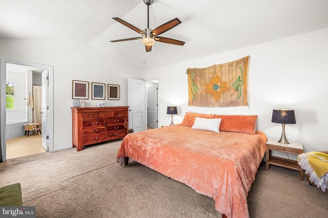 carpeted bedroom featuring ensuite bath, lofted ceiling, a ceiling fan, and baseboards