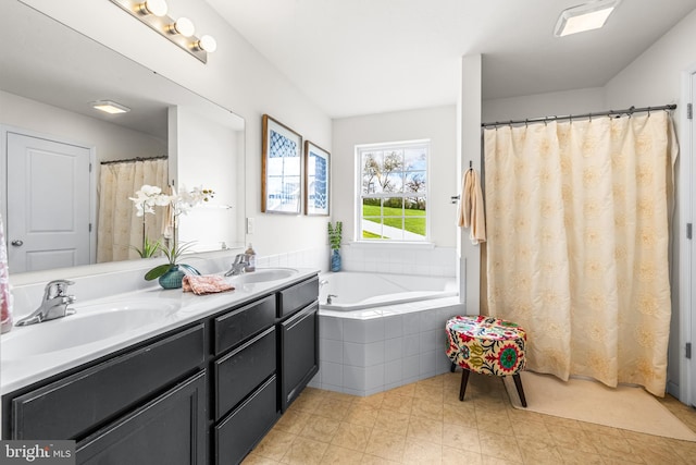 bathroom with a bath, a sink, and double vanity