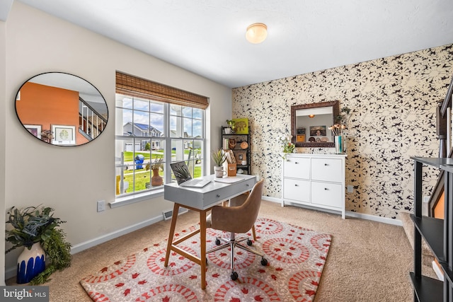 home office with light carpet, baseboards, and wallpapered walls