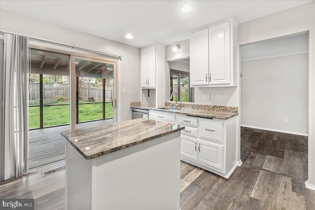 8794 Inspiration Ct, Walkersville, MD 21793 - kitchen with visible vents, stainless steel dishwasher, a sink, a kitchen island, and stone counters