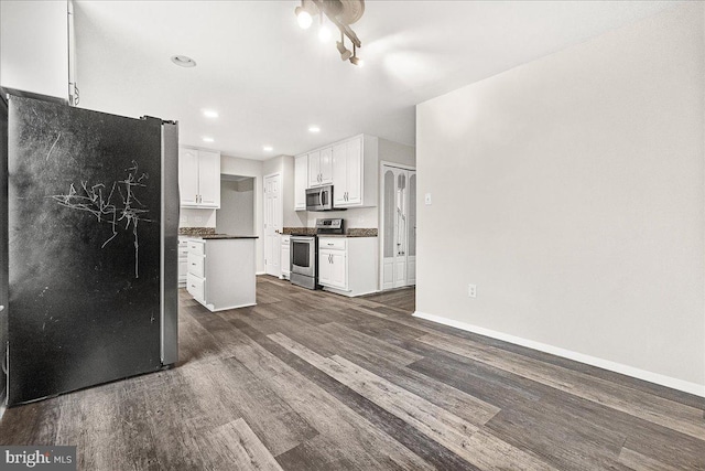 8794 Inspiration Ct, Walkersville, MD 21793 - kitchen featuring stainless steel appliances, dark countertops, white cabinetry, baseboards, and dark wood-style flooring
