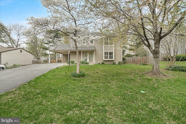 8794 Inspiration Ct, Walkersville, MD 21793 - traditional-style home with fence, aphalt driveway, a front yard, and a carport