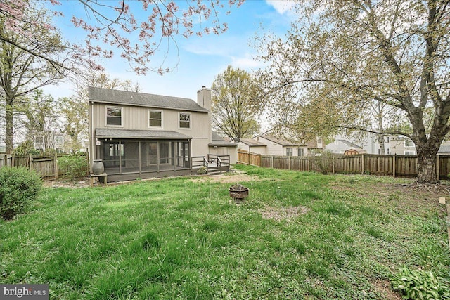 8794 Inspiration Ct, Walkersville, MD 21793 - back of property featuring a fenced backyard, a fire pit, a chimney, and a sunroom