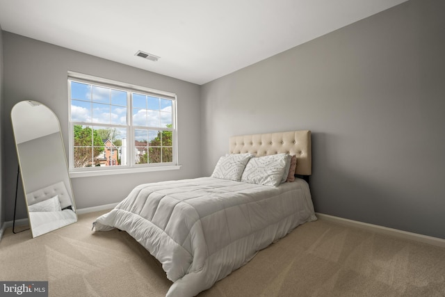 bedroom featuring baseboards, visible vents, and carpet