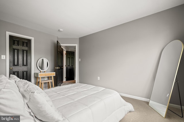 carpeted bedroom featuring baseboards