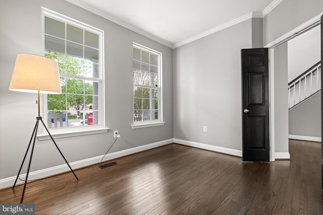 unfurnished bedroom with wood-type flooring, baseboards, visible vents, and ornamental molding