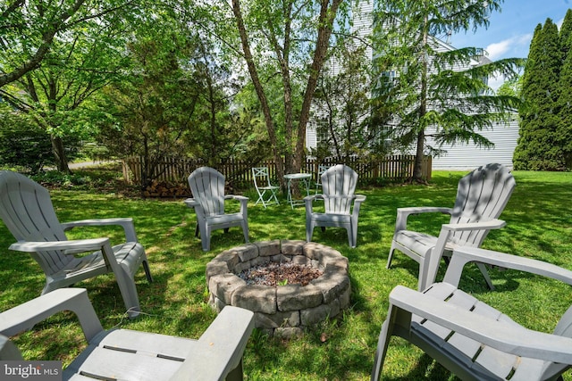 view of yard featuring fence and a fire pit