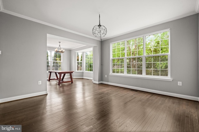 interior space with crown molding, dark wood-style flooring, baseboards, and a chandelier