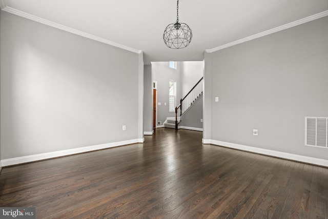 unfurnished room with visible vents, baseboards, dark wood-style floors, and stairway