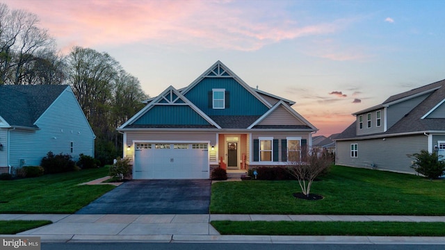 craftsman inspired home with a front yard, a garage, and driveway