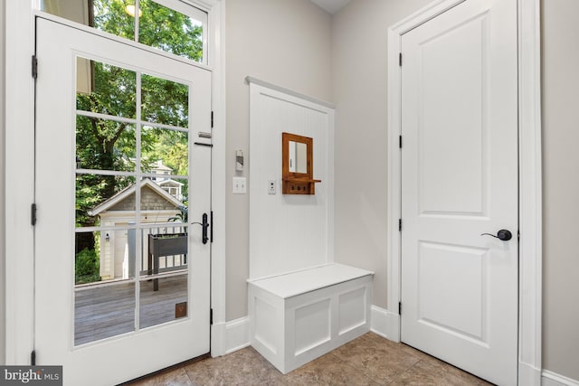 mudroom featuring baseboards and light tile patterned flooring