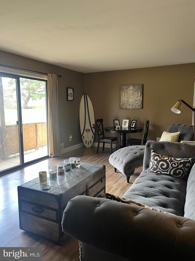 living area featuring baseboards and wood finished floors