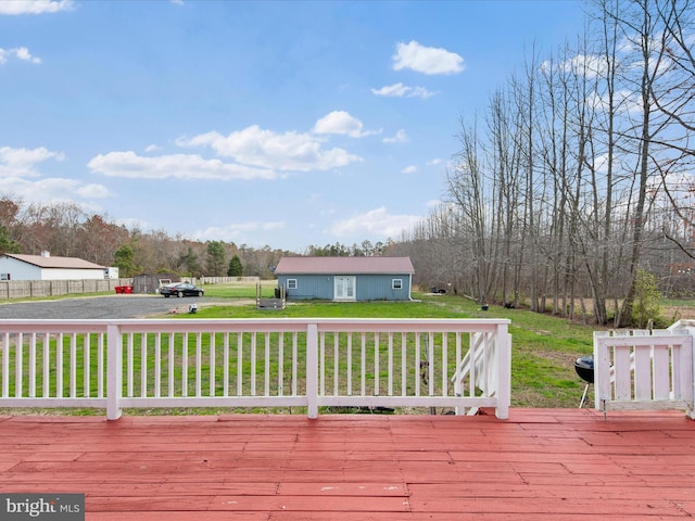 wooden terrace featuring a yard