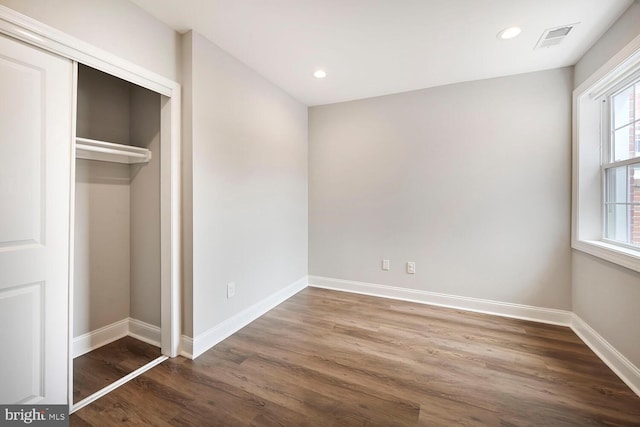 unfurnished bedroom with recessed lighting, visible vents, baseboards, and wood finished floors