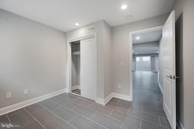 unfurnished bedroom featuring baseboards, visible vents, and recessed lighting