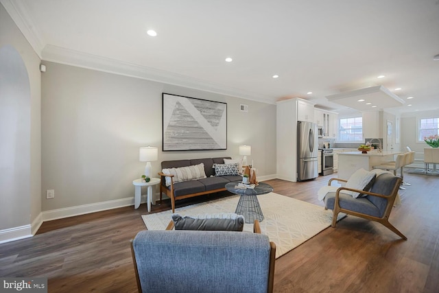 living room with crown molding, baseboards, recessed lighting, and wood finished floors
