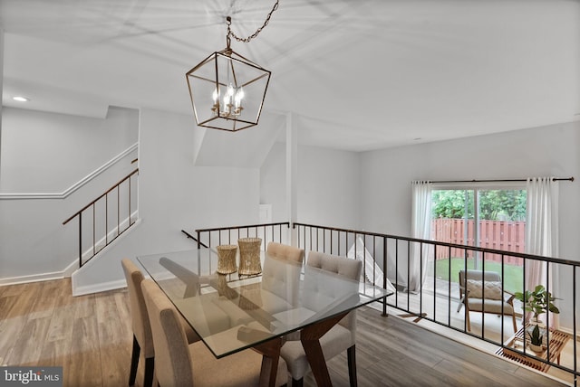 6335 Rockshire St, Alexandria, VA 22315 - dining area featuring wood finished floors, a chandelier, stairs, and baseboards