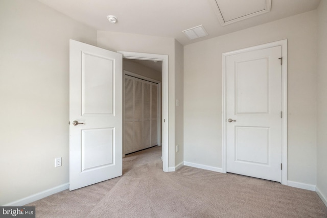 unfurnished bedroom with light colored carpet and baseboards