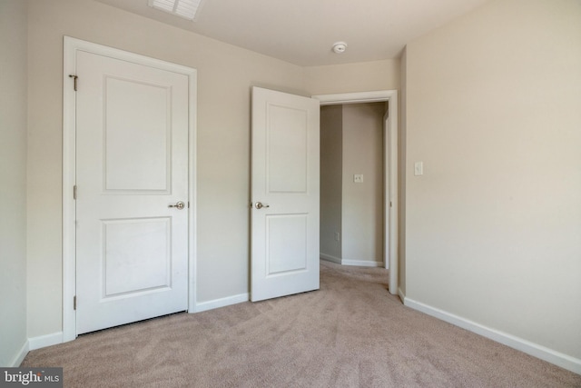 unfurnished bedroom with visible vents, baseboards, and carpet flooring