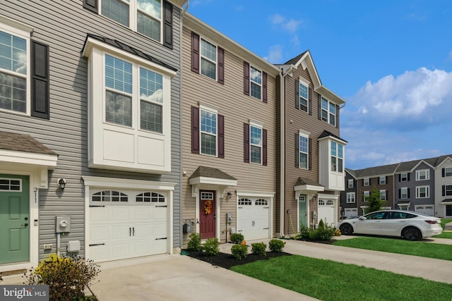 multi unit property with driveway, a garage, and a residential view