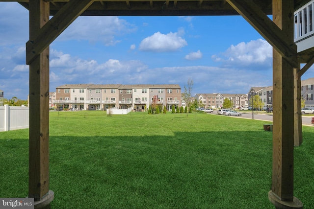 exterior space featuring fence and a residential view