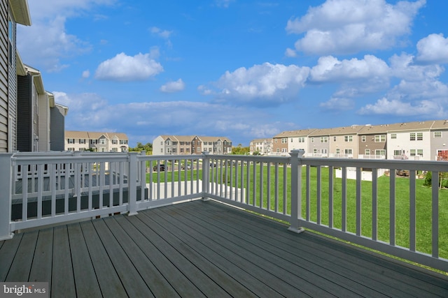 wooden deck featuring a yard and a residential view