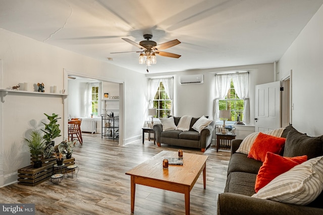 4870 Homeville Rd, Cochranville, PA 19330 - living area featuring radiator heating unit, a wall mounted AC, ceiling fan, and wood finished floors