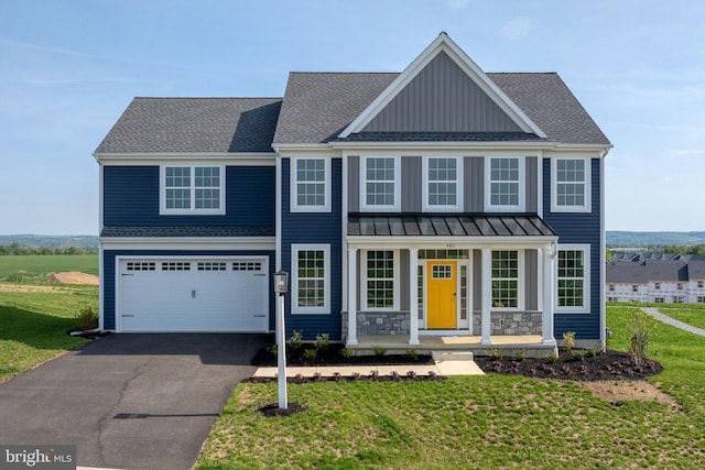 view of front of home with a porch, aphalt driveway, a front yard, and board and batten siding