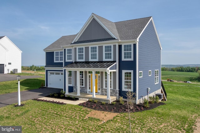 view of front of house with a porch, driveway, a front yard, central AC unit, and a standing seam roof
