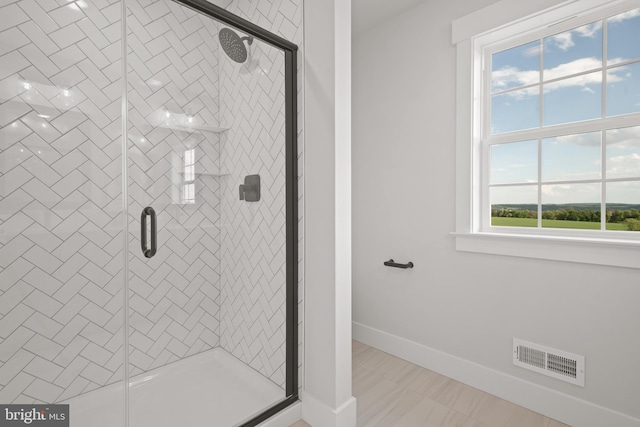 full bath featuring a stall shower, baseboards, and visible vents