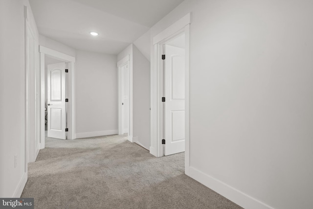 corridor featuring carpet, baseboards, and recessed lighting