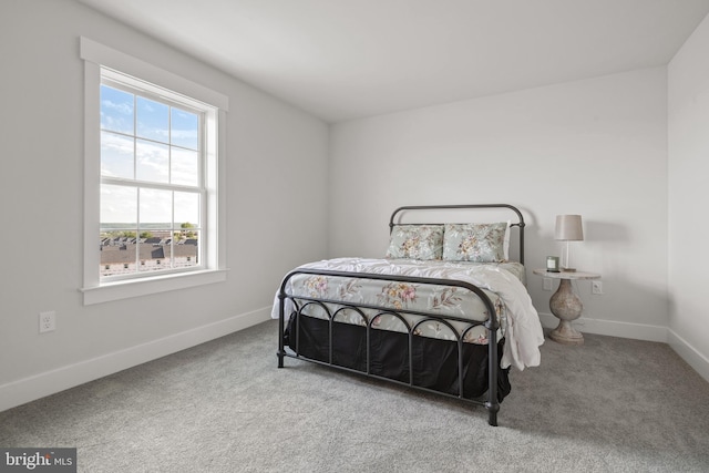 bedroom featuring carpet and baseboards