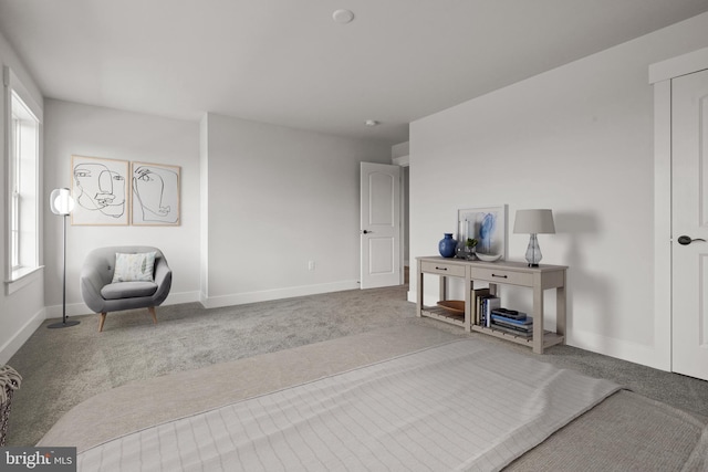 sitting room featuring carpet floors and baseboards