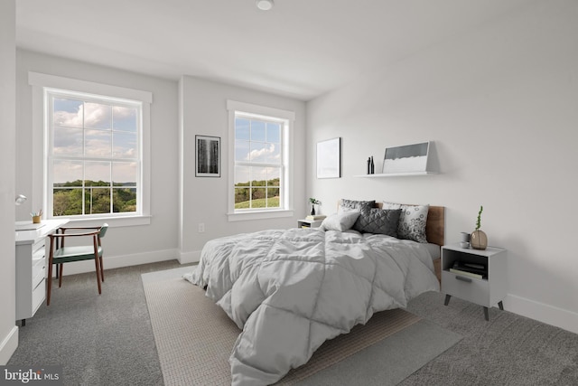 carpeted bedroom featuring baseboards