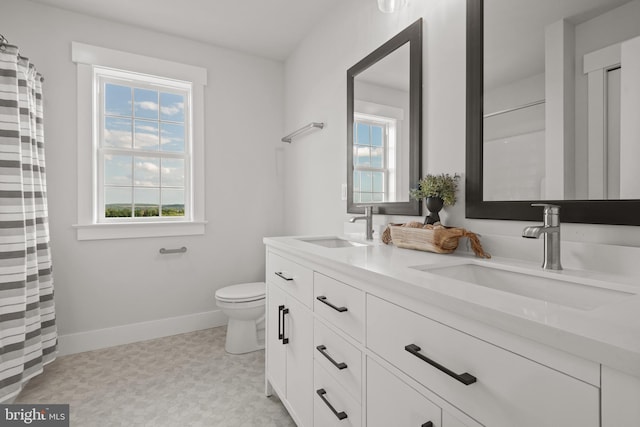 bathroom with a wealth of natural light, tile patterned floors, and a sink