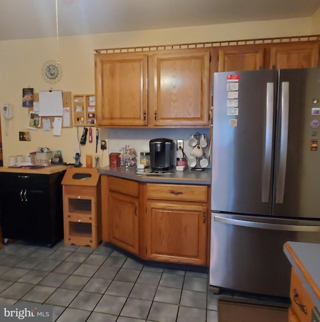 kitchen featuring light tile patterned floors and freestanding refrigerator
