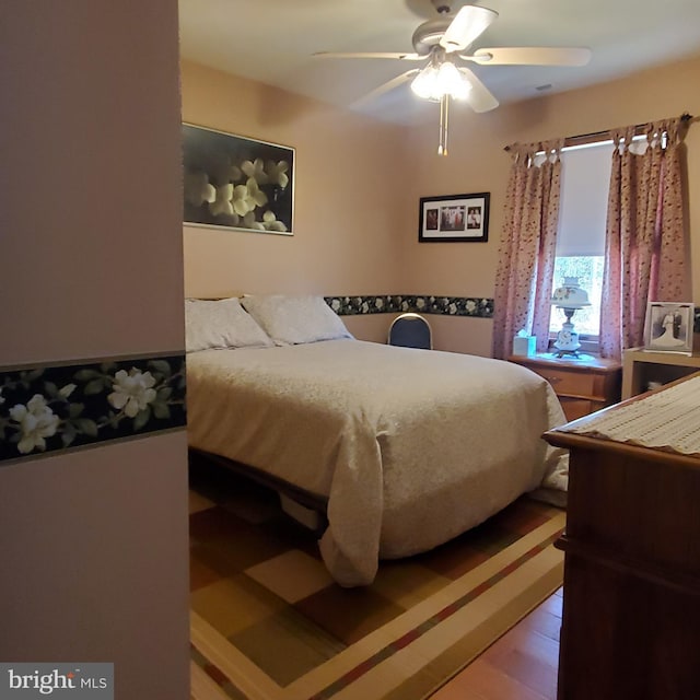 bedroom featuring wood finished floors and a ceiling fan