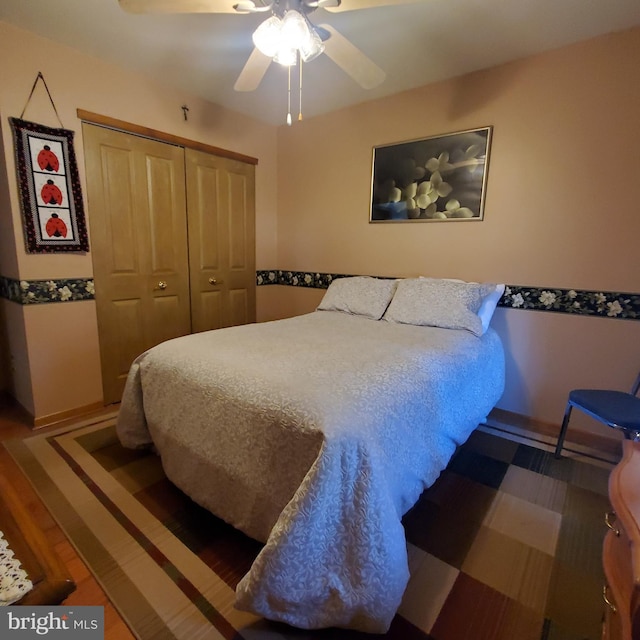 bedroom with ceiling fan and a closet