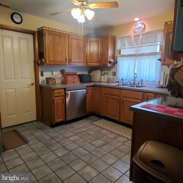 kitchen with stainless steel dishwasher, light tile patterned floors, a sink, visible vents, and a ceiling fan