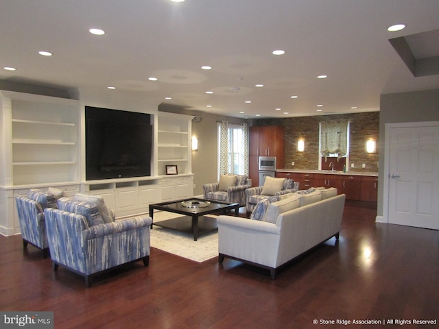 living room featuring recessed lighting, built in features, and dark wood-type flooring