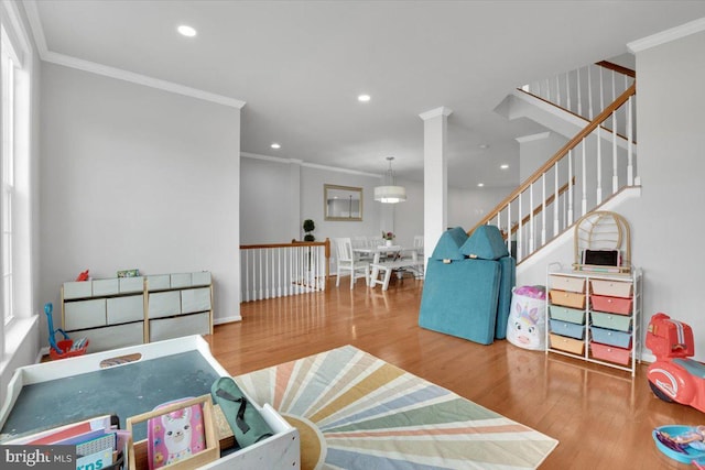 recreation room featuring crown molding, recessed lighting, and wood finished floors